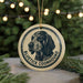 A circular ornament featuring a black and white illustration of a blue heeler dog, with the text "BLUEETICK COONHOUND" printed on it.