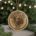 A round ornament with the text "BOERBOEL DOG" and a graphic of a dog's head is displayed in front of a Christmas tree with twinkling lights.