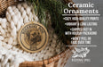 Ceramic ornaments, featuring a Börobel Dog ornament, are displayed in a woven basket with pine branches.