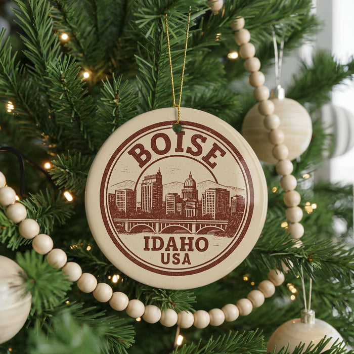 A circular ornament on a Christmas tree, featuring the text "BOISE IDAHO USA" and an illustration of a city skyline.