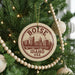 A circular ornament on a Christmas tree, featuring the text "BOISE IDAHO USA" and an illustration of a city skyline.