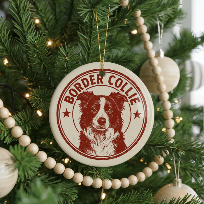 A Christmas tree decorated with ornaments, including a circular ornament with a Border Collie image and the text "BORDER COLLIE" printed on it.