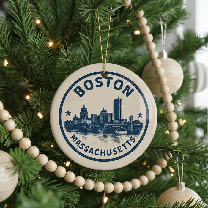 A circular ornament on a Christmas tree, featuring the silhouette of a city skyline and the text "BOSTON MASSACHUSETTS".