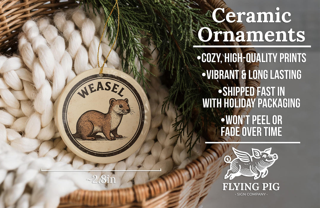 Ceramic ornaments, featuring a Weasel ornament with a cozy, high-quality print, a vibrant and long-lasting design, and fast shipping. The ornament is described as a "Shipped fast in with holiday packaging" and " Won't peel or fade over time". The image also includes a scale for the ornament's size, with the text "2.8in" and a logo for "FLYING PIG - SIGN COMPANY".