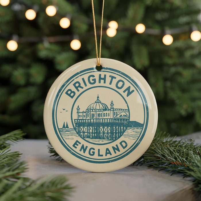 A circular ornament with the text "BRIGHTON ENGLAND" and an illustration of a building, likely a landmark, is hanging from a string.