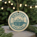 A circular ornament with the text "BRIGHTON ENGLAND" and an illustration of a building, likely a landmark, is hanging from a string.