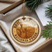 A circular ornament with the text "BRYCE CANYON NATIONAL PARK USA" printed on it, hanging from a string.