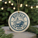 A circular ornament with the text "BUFFALO NEW YORK USA" and an illustration of a buffalo, hanging from a string.