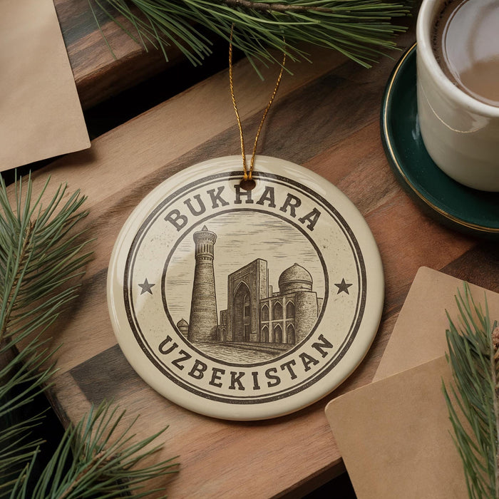 A circular ornament with the text "BUKHARA UZBEKISTAN" and an illustration of a mosque, hanging on a wooden surface.