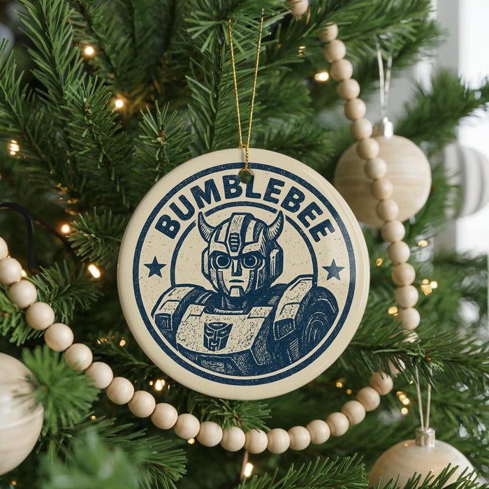 A circular ornament on a Christmas tree featuring a Bumblebee character from the Transformers franchise.