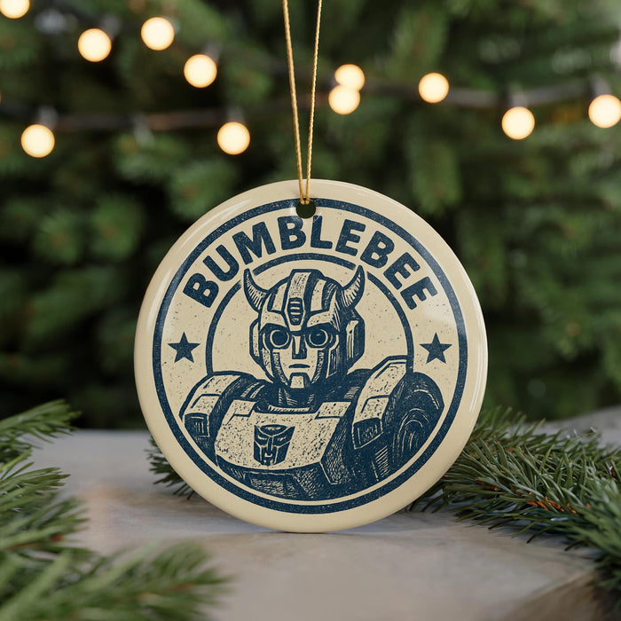 A circular ornament featuring a robot or character with horns and a star on it, with the text "BUMBLEBEE" around the edge.