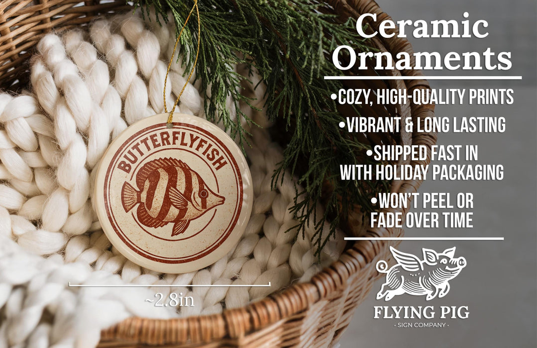 Ceramic ornaments, featuring a butterflyfish design, are displayed in a woven basket.