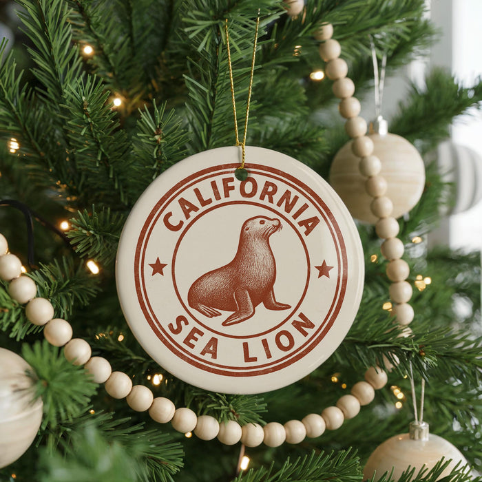 A Christmas tree decorated with ornaments, including a circular ornament with a seal and the text "CALIFORNIA SEA LION".