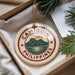 A decorative ornament with the text "CAMIGUIN PHILIPPINES" and a mountain landscape design, hanging from a string.