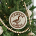A Christmas tree decorated with ornaments, including a circular ornament with a goose and the text "CANADA GOOSE" on it.