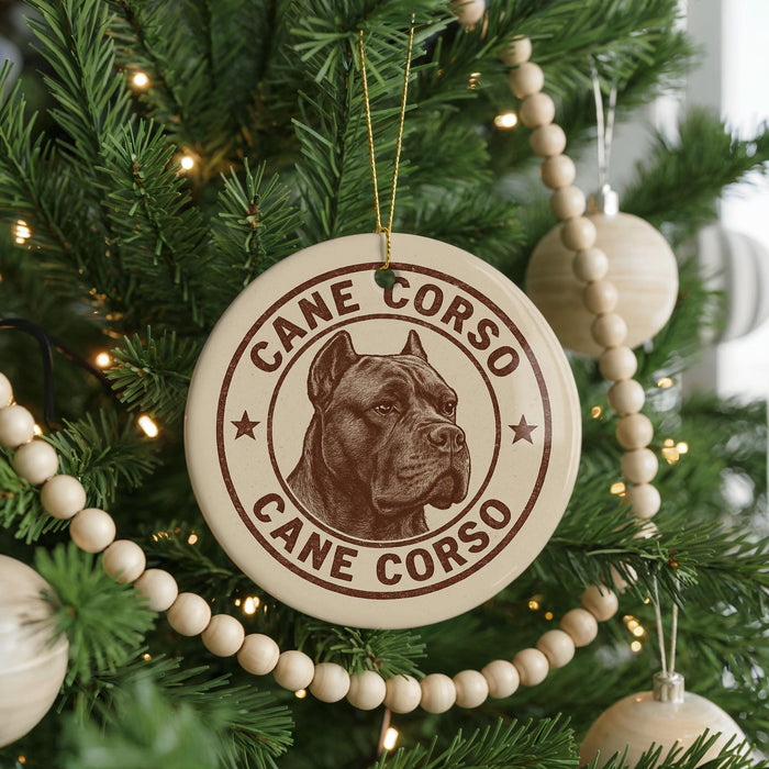 A Christmas tree decorated with ornaments, including a large circular ornament with a picture of a dog's head and the text "CANE CORSO" around it.