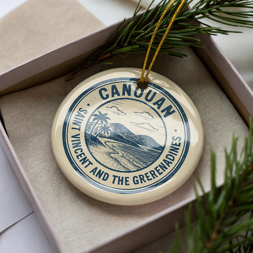 A circular ornament with the text "CANUAN SAINT VINCENT AND THE GREEMENADINES" printed on it, surrounded by pine branches.