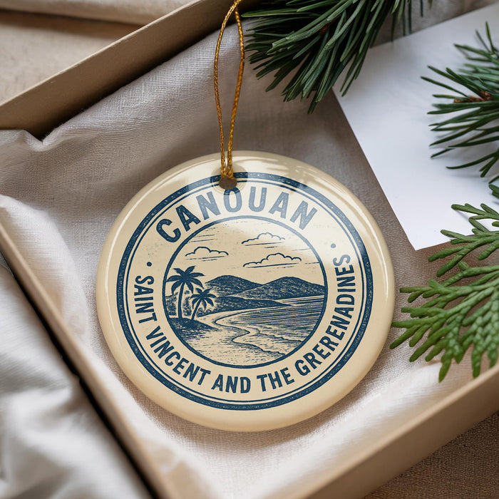A circular ornament with the text "CANOUAN SAINT VINCENT AND THE GREEMANDINES" printed on it, hanging from a string.