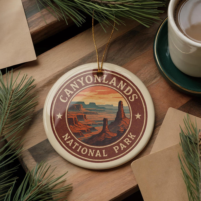 A decorative ornament featuring a scenic image of the Grand Canyon National Park, surrounded by pine branches and a cup of coffee on a wooden surface.