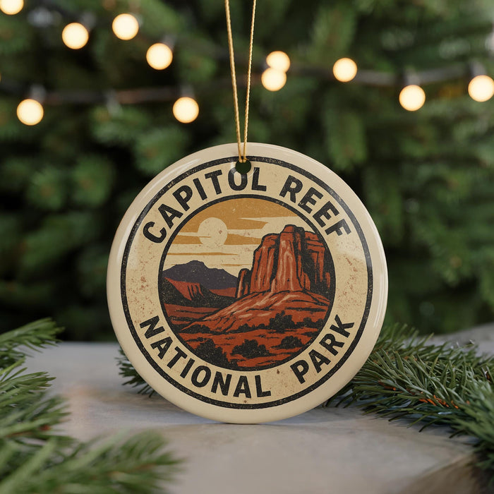 A circular ornament with the text "CAPITOL REEF NATIONAL PARK" and an illustration of a desert landscape with mountains in the background.