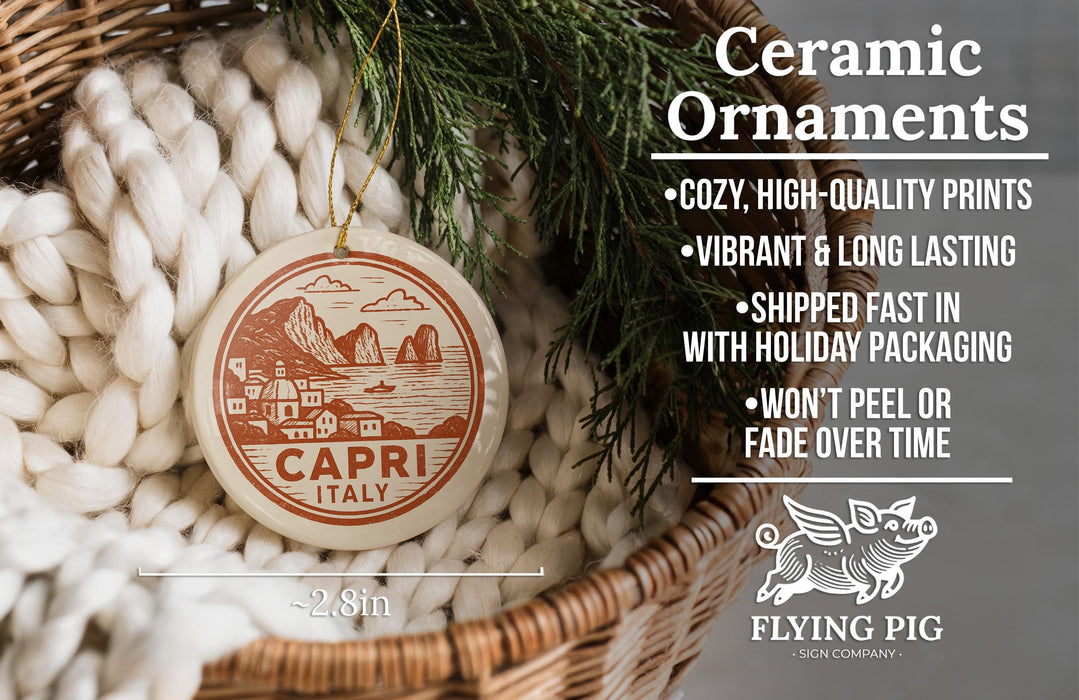 Ceramic ornaments, specifically a ceramic ornament with a design of a coastal town, are displayed in a woven basket.