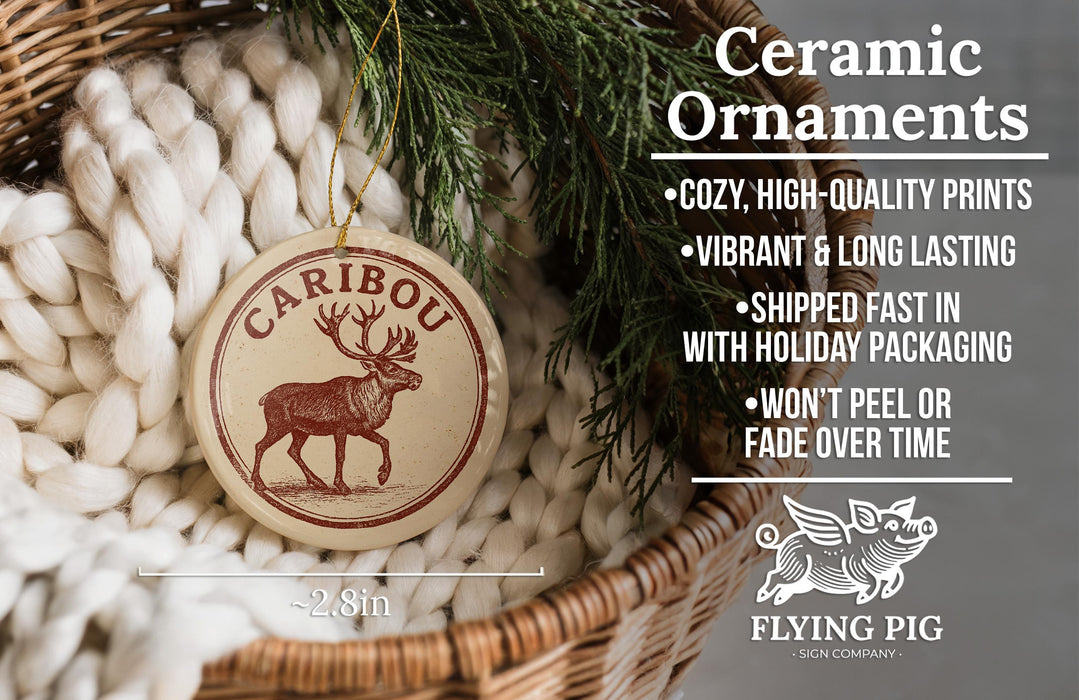 a ceramic ornament hanging from a wicker basket, with a pine branch and greenery in the background.