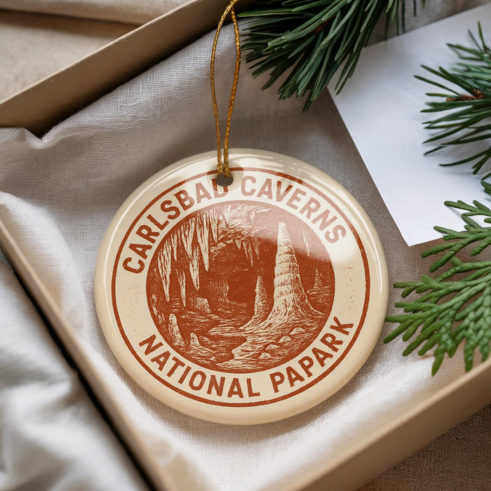 A circular ornament with the text "CARLSBAD CAVENS NATIONAL PAPARK" printed on it, hanging from a string.