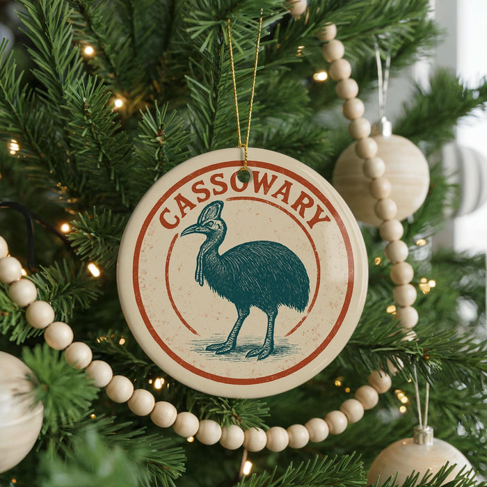 A Christmas tree decorated with ornaments, including a circular ornament with a bird image and the word "CASSOWARY" written on it.
