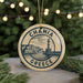 A circular ornament with the text "CHANIA GREECE" and an illustration of a lighthouse and buildings, hanging from a string.