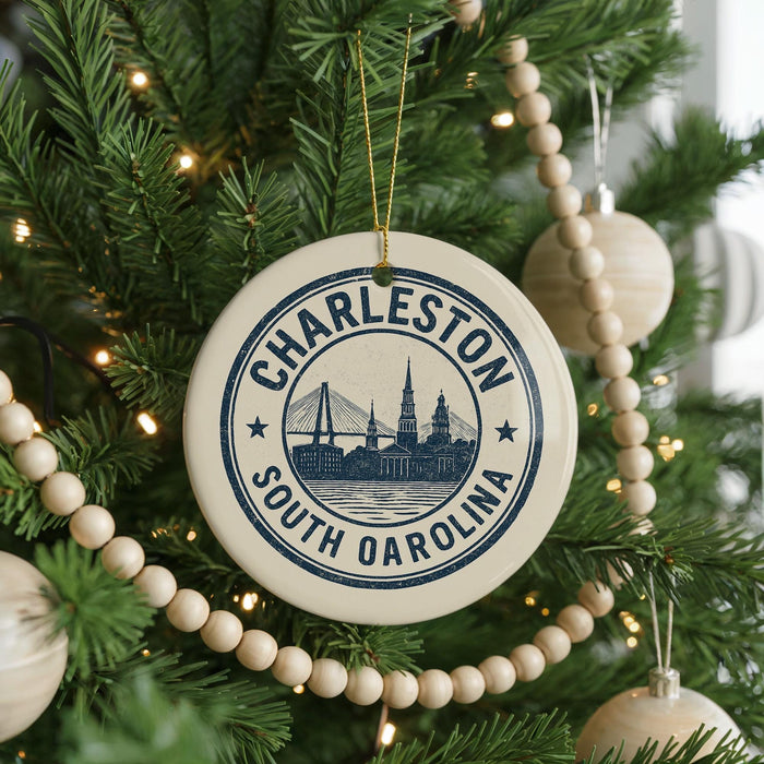 A Christmas tree decorated with ornaments, including a circular ornament with the text "CHARLESTON SOUTH OREGON" and a suspension bridge design.