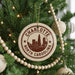 A Christmas tree decorated with ornaments, including a circular ornament with the text "CHARLOTTE NORTH CAROLINA" and a city skyline image.