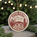 A round ornament with a red and white design depicting a city skyline and mountains, with the text "CHENGU CHINA" prominently displayed.