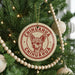 A Christmas tree decorated with ornaments, including a circular ornament with a chihuahua image and the text "CHIHUAHUA CHIHUAHUA" printed on it.