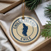 A decorative ornament with the text "CHILE" and a map of Chile, placed in a box with pine branches.