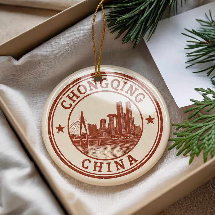 A decorative ornament with the text "CHONGQING CHINA" and an illustration of a city skyline, hanging from a string.