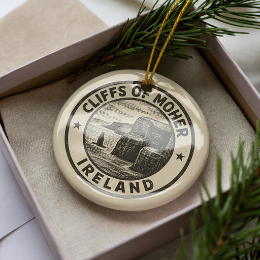 A circular ornament with the text "CLIFFS OF MOHER ISLAND" printed on it, surrounded by pine branches.