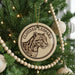 A Christmas tree decorated with ornaments, including a circular ornament featuring a leopard's face and the text "CLOUDED LEOPARD".