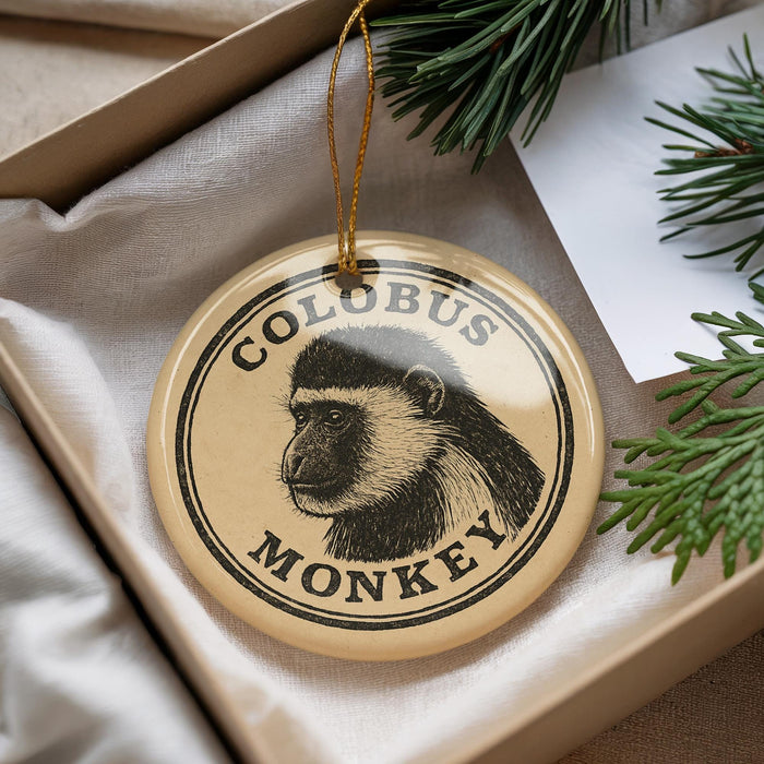 A round ornament with a monkey's face on it, hanging from a string.