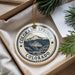 A decorative ornament with the text "COLORADO SPRINGS COLORADO USA" printed on it, hanging from a string.