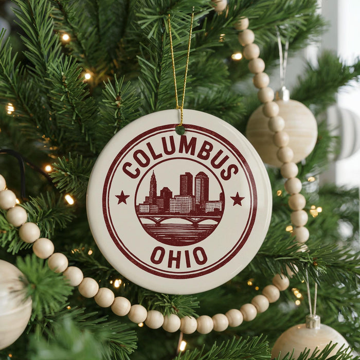 A Christmas tree decorated with ornaments, including a circular ornament with the text "Columbus, Ohio" and a cityscape design.