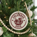 A Christmas tree decorated with ornaments, including a circular ornament with the text "Columbus, Ohio" and a cityscape design.