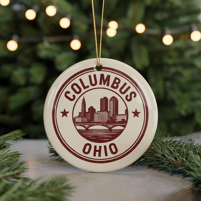 A circular ornament with the text "COLUMBUS OHIO" and a graphic of a city skyline, hanging from a string.