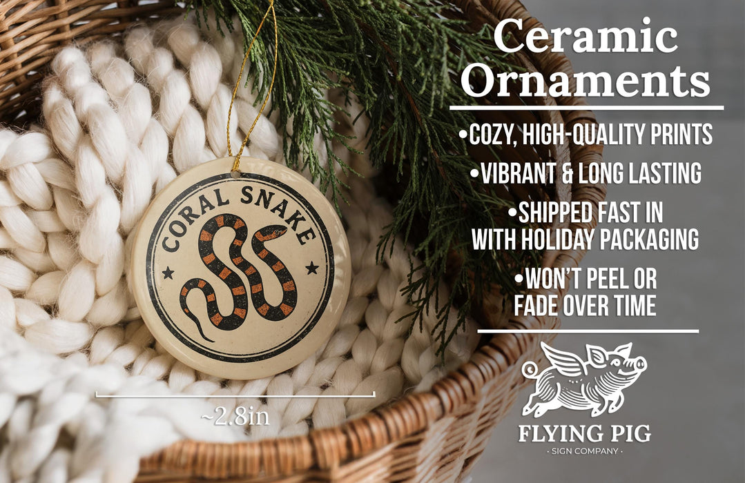 a ceramic ornament in a basket, with a wicker basket and greenery in the background. The ornament has a snake design and is described as a ceramic ornament.