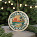 A circular ornament with a tropical beach scene and palm trees, featuring the text "Cox's Bazar Bangladesh" on it.
