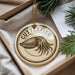 A round ornament with the word "CUTTLEFISH" printed on it, featuring an illustration of an octopus.
