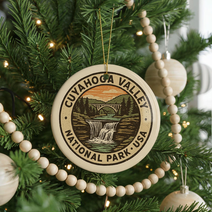 A Christmas tree decorated with ornaments, including a circular ornament with the text "CUYAHOGA VALLEY NATIONAL PARK, USA" and a waterfall image.