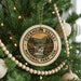 A Christmas tree decorated with ornaments, including a circular ornament with the text "CUYAHOGA VALLEY NATIONAL PARK, USA" and a waterfall image.