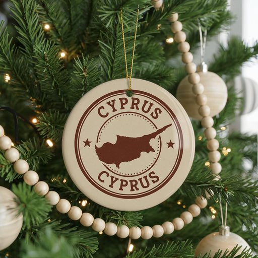 A Christmas tree decorated with ornaments, including a circular ornament with the text "CYPRUS" and a map of the island of Cyprus.