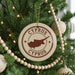 A Christmas tree decorated with ornaments, including a circular ornament with the text "CYPRUS" and a map of the island of Cyprus.