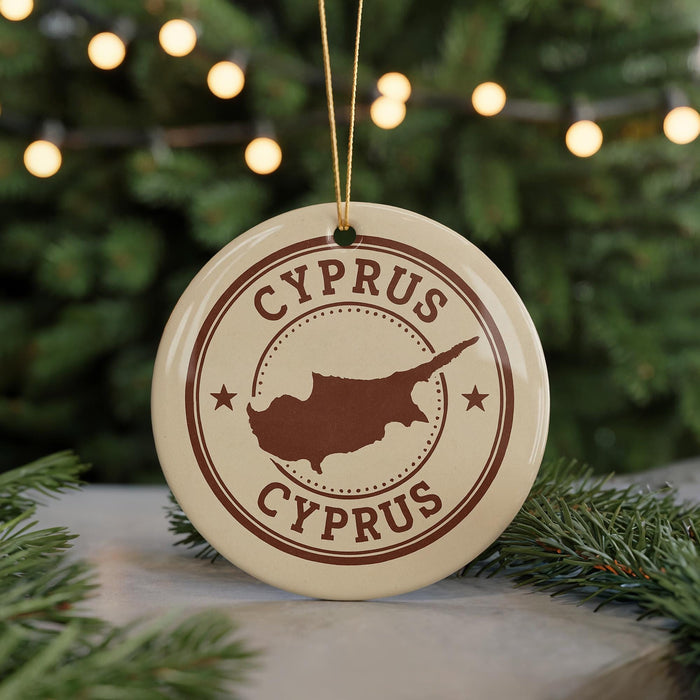 A circular ornament with the text "CYPRUS" and a map of the island of Cyprus, surrounded by Christmas lights and greenery.